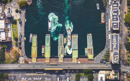 An aerial view of the wharves at Circular Quay, with ferries coming and going - Australian Stock Image