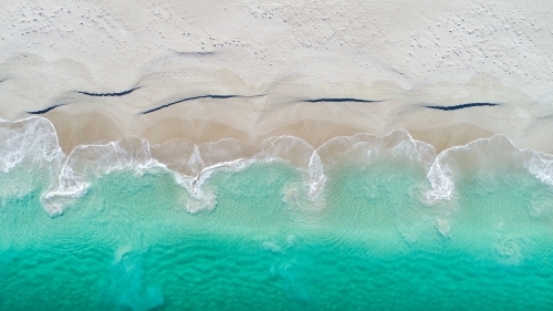 An aerial view of water receeding into the ocean