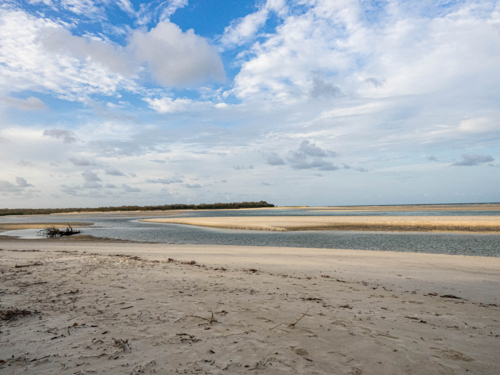 An empty beach with water inlet into a bay - Australian Stock Image