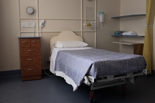An empty hospital bed in a hospital - Australian Stock Image