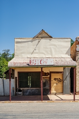 An old abandoned butcher shop with bars over the windows - Australian Stock Image