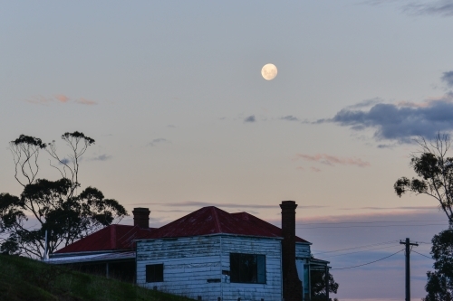 An old country homestead under a full moon - Australian Stock Image
