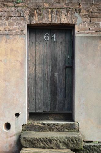 An old door on a sandstone house.