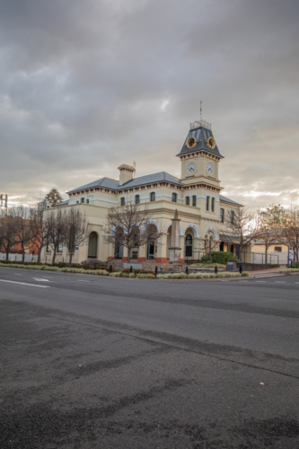 An old town Post Office building with a clock tower under grey skies - Australian Stock Image