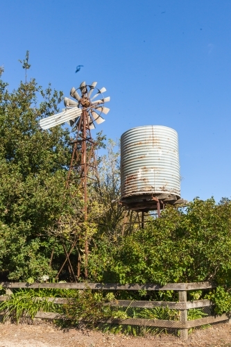 An old water tank and wind mill - Australian Stock Image