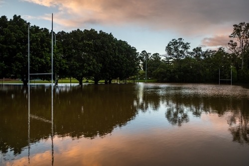 An open field flooded with water mirroring the sky. - Australian Stock Image