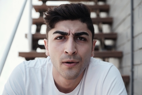 Angry multicultural young adult man, university student - Australian Stock Image