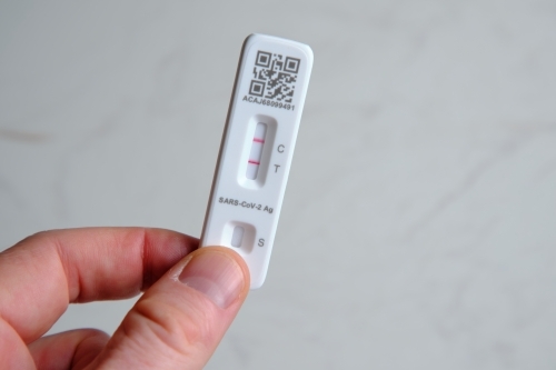 Antigen rapid test kit showing a positive result - Australian Stock Image
