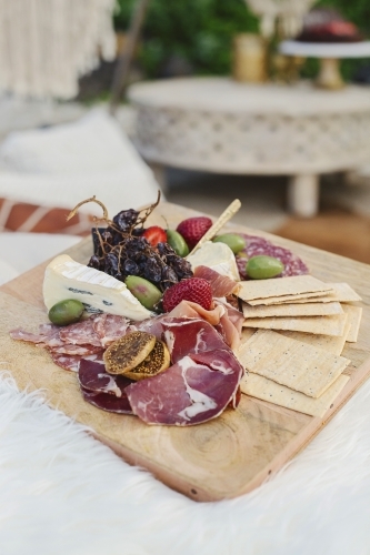 Antipasto platter with boho details in the background - Australian Stock Image