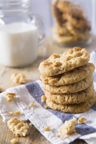 Anzac Biscuitss with milk on a chopping board - Australian Stock Image