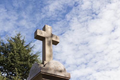ANZAC Memorial Cross against blue cloudy sky - Australian Stock Image