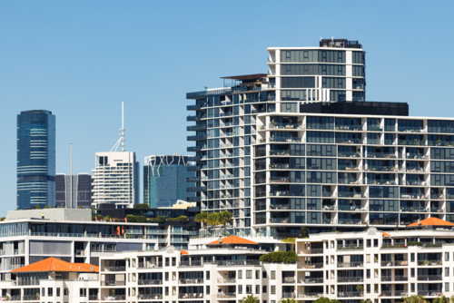 Apartment buildings adjacent to the Brisbane River with skyscrapers in the background - Australian Stock Image