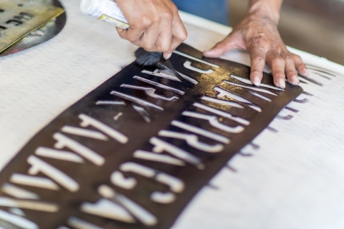 Applying a stencil on a wool bale - Australian Stock Image