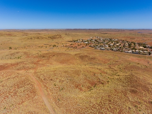 arid Pilbara landscape with cluster of houses - Australian Stock Image