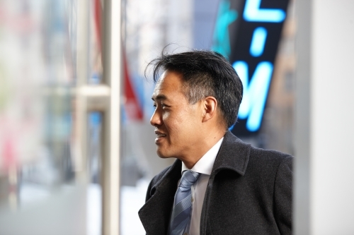 Asian businessman in city - Australian Stock Image