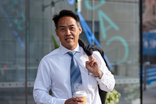 Asian businessman in city - Australian Stock Image