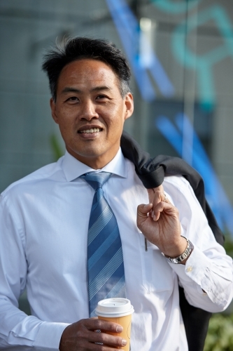 Asian businessman in city - Australian Stock Image