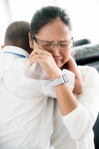 Asian mother cries as she sends her boy off to his first day of school - Australian Stock Image