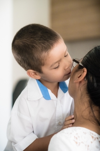 Asian mum saying good-bye to her son on his first day of school - Australian Stock Image