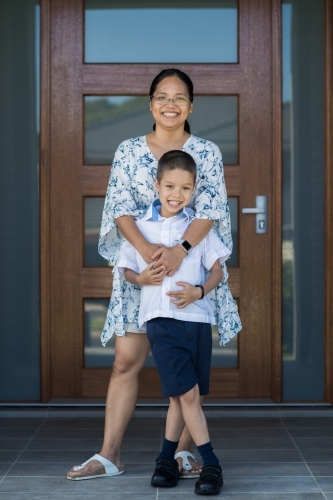 Asian mum sending her boy off to school on his first day of school - Australian Stock Image