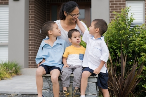 Asian mum sending her boys off to school on their first day of school - Australian Stock Image