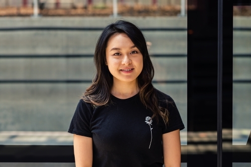 asian woman at train station - Australian Stock Image