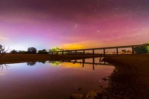 Aurora Australis colours in the sky over a viaduct bridge at Joyces Creek in Central Victoria - Australian Stock Image