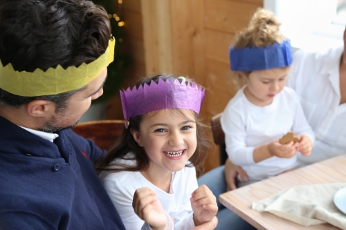 Dad with daughter smiling wearing Christmas hats - Australian Stock Image
