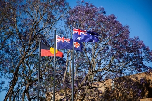 Australian, Aboriginal, and New South Wales flag flying side by side - Australian Stock Image