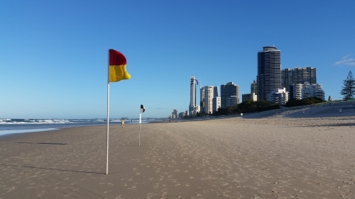 Australian Beach on the Gold Coast with flags and high rise buildings - Australian Stock Image