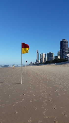 Australian Beach on the Gold Coast with flags and high rise buildings - Australian Stock Image