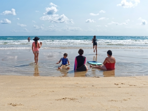 Australian Coastal living with a family enjoying the summer beach, sand and surf