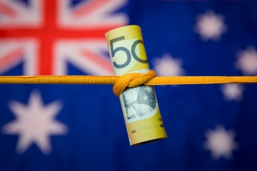 Australian Fifty Dollar Note Tied in a Knot with flag - Australian Stock Image