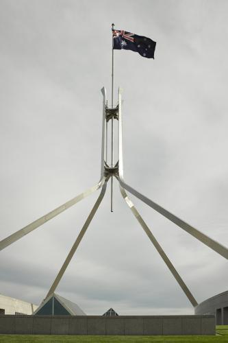 Australian Flag flying at Parliament House on an overcast day
