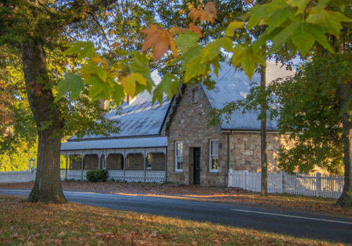 Autumn leaves and a stone cottage - Australian Stock Image