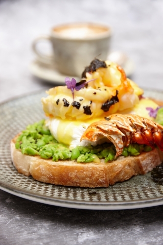 Avocado toast with poached egg and lobster - Australian Stock Image
