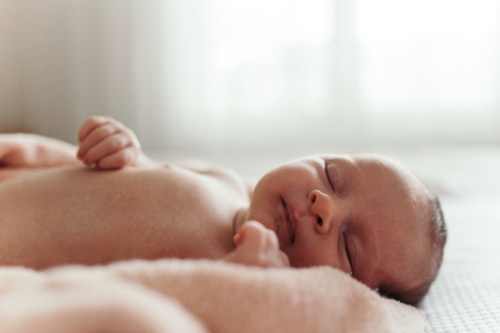baby girl wrapped in a blanket sleeping. - Australian Stock Image