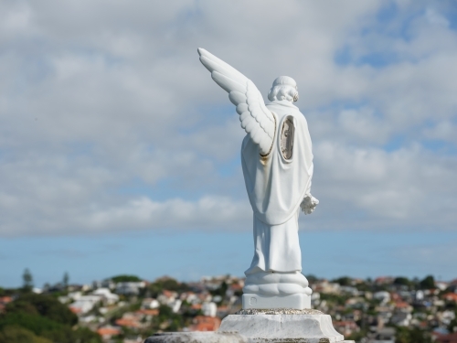 back shot of an angel sculpture with one wing - Australian Stock Image