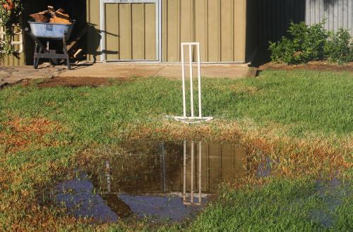 Backyard cricket - Too wet for play - Australian Stock Image