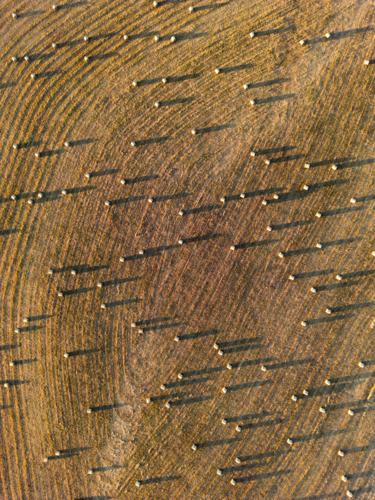 Bales of hay dotted on the ground looking from above - Australian Stock Image