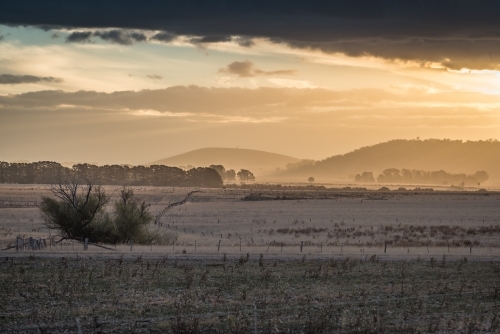 Ballarat region sunset over dry paddock - Australian Stock Image