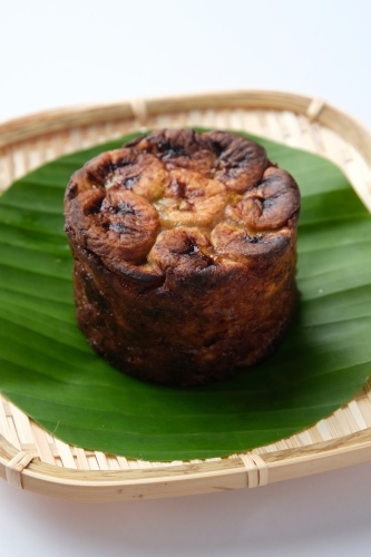 Banh Chuoi Nuong served on a banana leaf in a woven plate. - Australian Stock Image