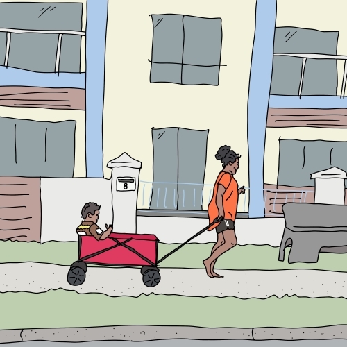 Barefoot aboriginal woman happily pulling boy in trolley - Australian Stock Image