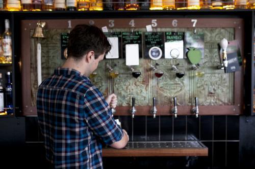 Bartender pouring a tap beer at a local craft beer bar