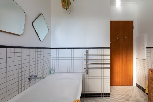 Bathroom renovation with vintage mirrors above bath - Australian Stock Image