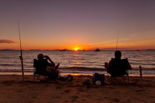 Beach fishermen at sunset.