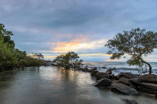 Beach lagoon with colourful sky - Australian Stock Image