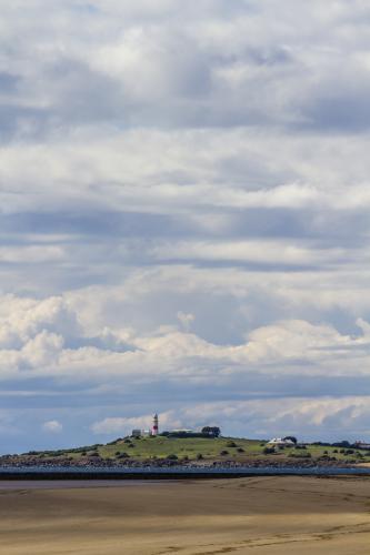 Beach Landscape with Low Head Lighthouse in Distance - Australian Stock Image