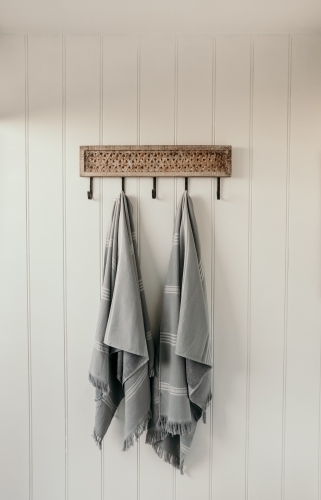 Beach towels waiting on a hook. - Australian Stock Image