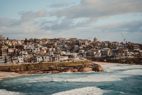 Beachfront property on North Bronte headland and Tamarama on a sunny morning - Australian Stock Image